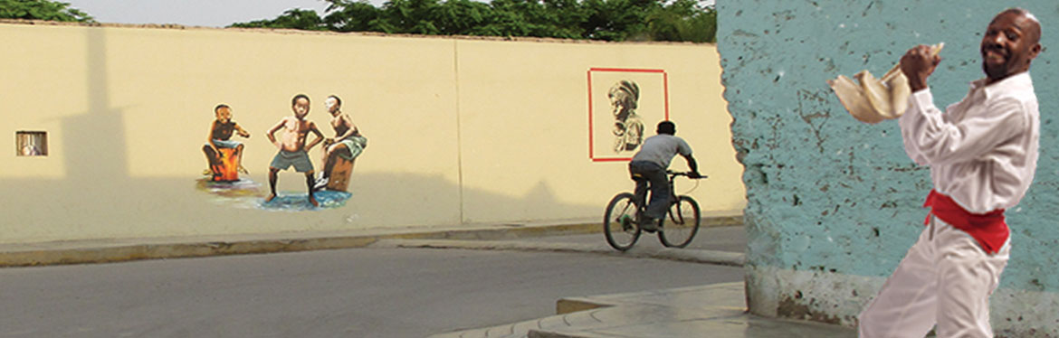 street in El Carmen, Peru, with Lalo Izquierdo holding quijada de burro